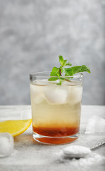 Glass with mint julep on table