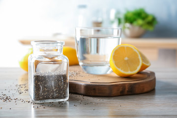 Composition with chia seeds, water and lemon on kitchen table