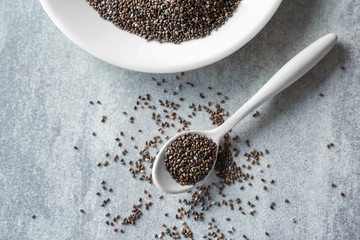 Chia seeds in spoon on table