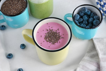 Smoothie with chia seeds in metal cup on table