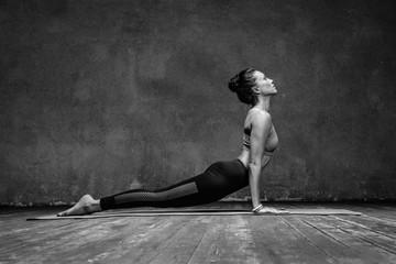 Young beautiful yoga female posing in studio - obrazy, fototapety, plakaty