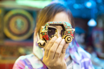 Little car souvenir in hands woman tourist.
