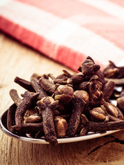 Spice cloves on kitchen spoon