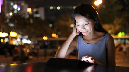 Woman use of tablet computer in city