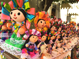 Many colorful artisian dolls on a mexican market 