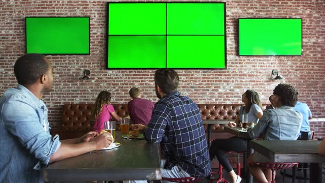 Friends Watching Game In Sports Bar On Screens Shot On R3D