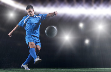 soccer player in front of big modern stadium with flares and lights