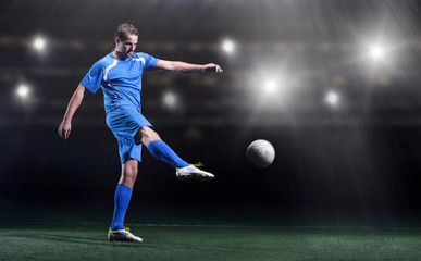 soccer player in front of big modern stadium with flares and lights