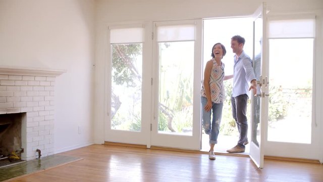 Excited Couple Explore New Home On Moving Day
