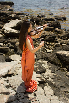 girl in orange dress with violin