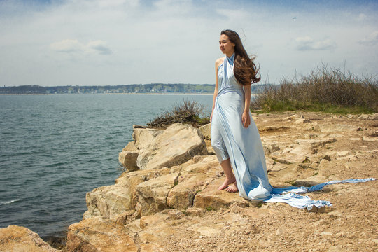 Girl in blue dress on a cliff 7