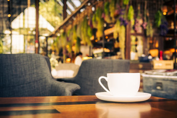 Hot latte coffee in white cup on table in restaurant and cafe