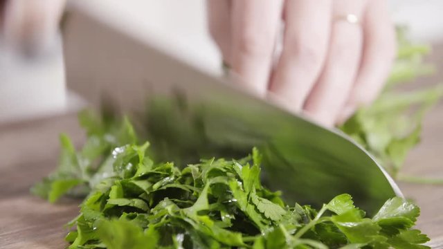 Close Up, Chef Dices Parsley On Cutting Board