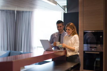 A young couple is preparing for a job and using a laptop