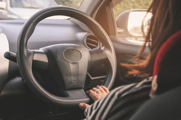 Fototapeta premium Close up of young attractive woman is driving a car.