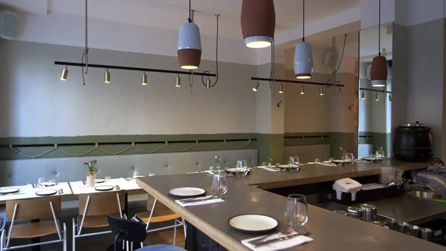 Camera slider shot of empty tables and bar in a restaurant