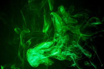 Fototapeta na wymiar Green smoke motion on black background.