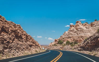 Stone desert in the USA. A picturesque road in the lifeless red rocks of Arizona
