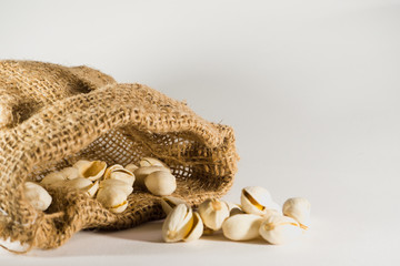 Pistachios in a sackcloth isolated on white background