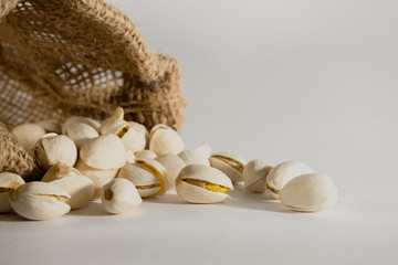 Pistachios in a sackcloth isolated on white background