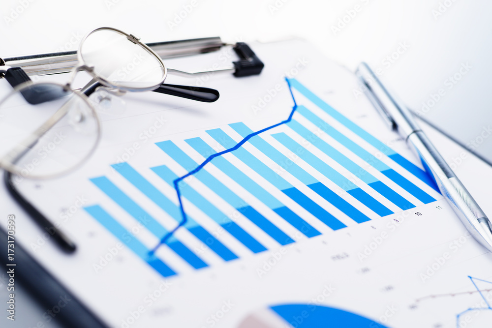 Aufkleber close up of blue growth chart. glasses and pen. concept image of analyzing data.