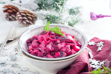 Obraz na płótnie Canvas Salad with beets and herring in festive Christmas decorations, horizontal