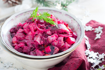Salad with beets and herring in festive Christmas decorations, horizontal