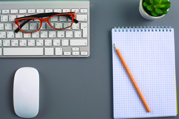 office desk with laptop, pen, and notebook. Top view