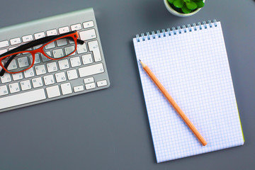 office desk with laptop, pen, and notebook. Top view