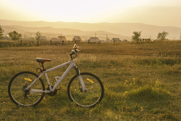 Fototapeta na wymiar White Bicycle in the middle of a rural field