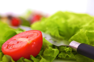 salad from fresh vegetables in a plate on a table, selective focus