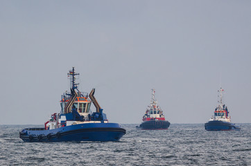 TUGS - Two tugs and fireboat at sea © Wojciech Wrzesień