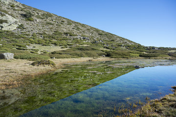 Glacial lagoon next to the Pico del Nevero (Snowfield Peak; 2.209 metres), in Guadarrama Mountains National Park, Madrid, Spain
