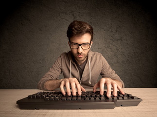 Computer geek typing on keyboard
