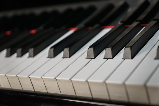 Piano keys on black classical grand piano play