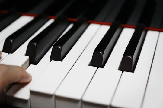 Piano keys on black classical grand piano - closeup for music production and recording