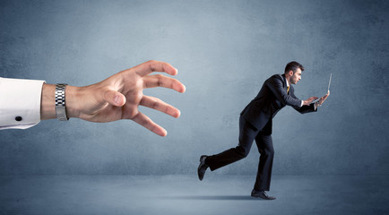 Businessman running from hand