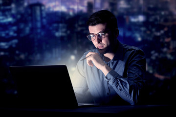 Businessman in the office at night