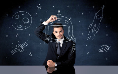 Sales person drawing helmet and space rocket