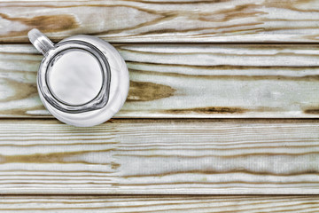 A jug of milk on a wooden.