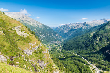 Aerial view of an alpine valley, example of glacial valley. Anzasca Valley,at the foot of Mount Rosa, with the characteristic villages of Macugnaga (Staffa - Pecetto) and Borca, Piedmont, Italy