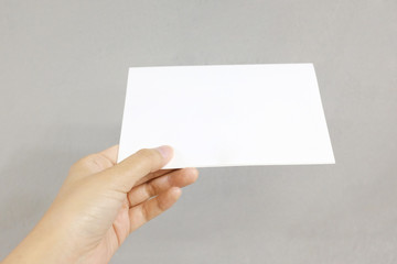 A hand holding a paper card