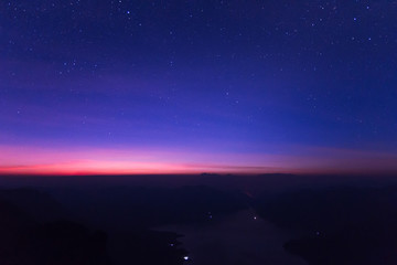 The milky way rises over the Mae Ping national park at sunrise, Pha dang luang view point  Li, Lamphun in Thailand 