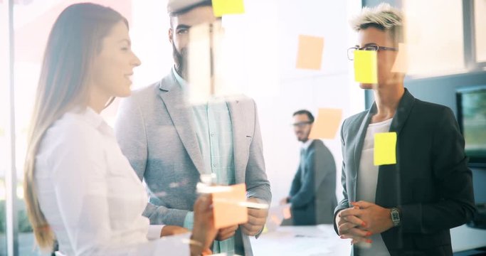 Picture of designers sticking notes in office