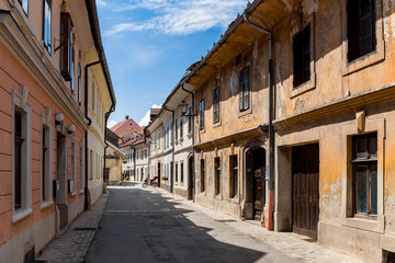 Fototapeta na wymiar Old streets of Kranj town in Slovenia yellow walls empty no people day time Europe