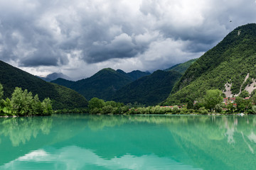 Naklejka na ściany i meble Large green lake under the mountains quiet water panoramic landscape nature of Europe Slovenia day time summer sunny 