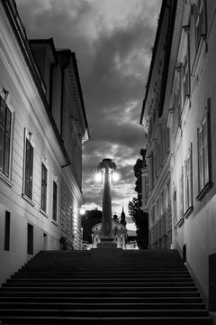 Narrow street and the stairs leading to the monument in the center of Ljubljana 