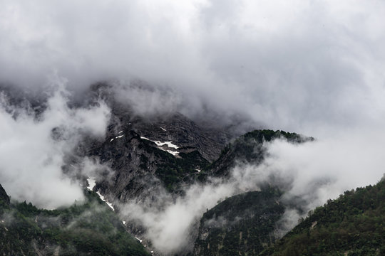 Slovenija mountain tops covered with the clouds and fog during the day