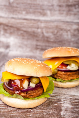 Close up of Delicious tasty burgers on wooden background. Fast and tasty food
