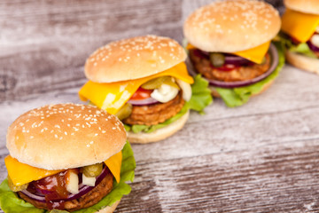 Close up of Delicious tasty burgers on wooden background. Fast and tasty food